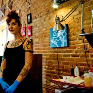Karen Hall prepares to work on a client who asked for a traditional sleeve.  Karen is the owner and an artist at Elemental Ink, but will be tattooing in Ireland as a guest at several tattoo shops during her trip.